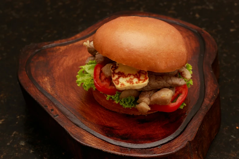 a close up of a wooden tray with a sandwich