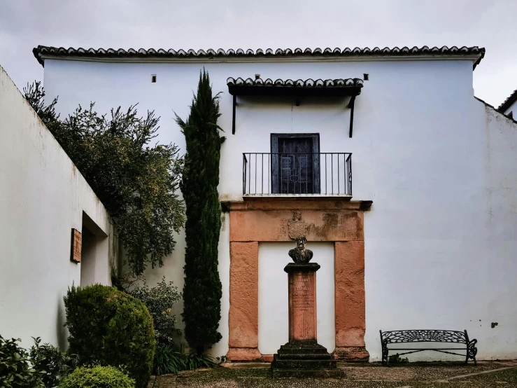 a house that has a bench in the front