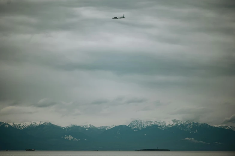 a plane flying high over the snowy mountains