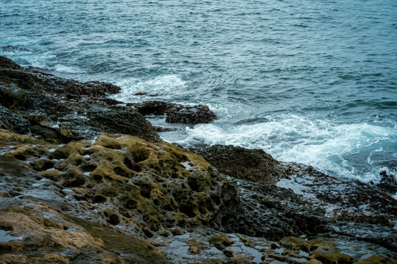 a large body of water next to rocky shore