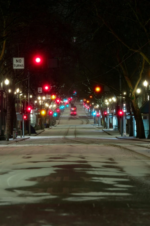 traffic lights and pedestrian crossing lights shine brightly in the night