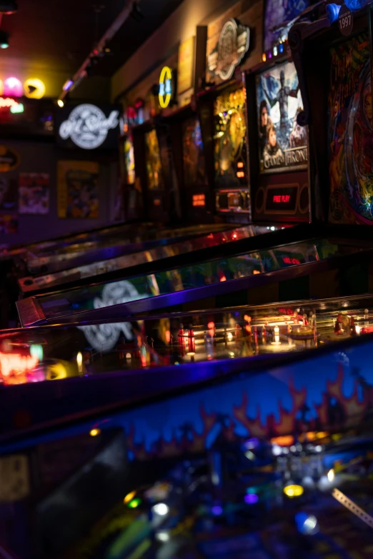 rows of pinball machines sit on the table