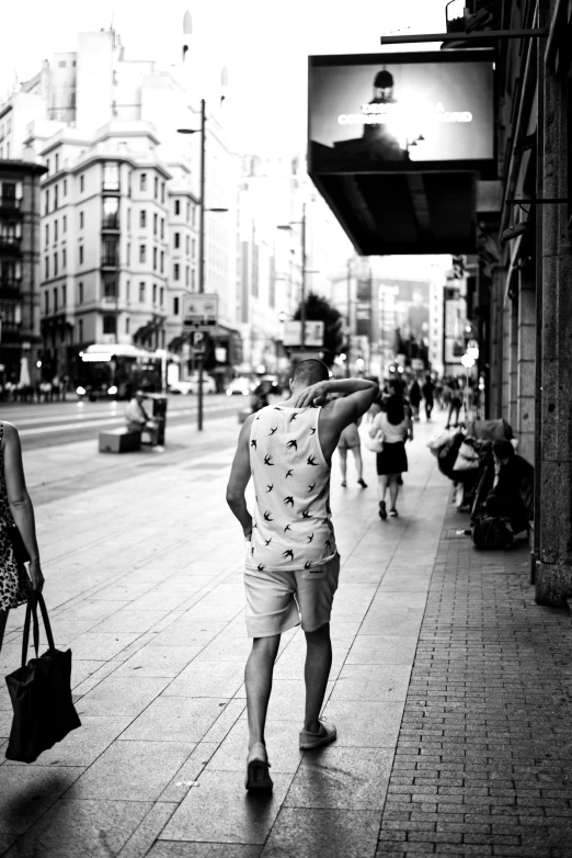 a young man is walking down the street