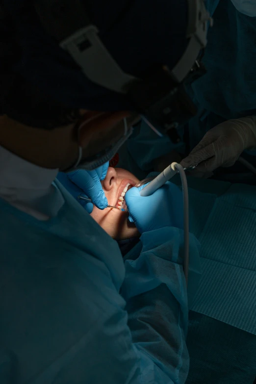 a dentist working on an adult patient