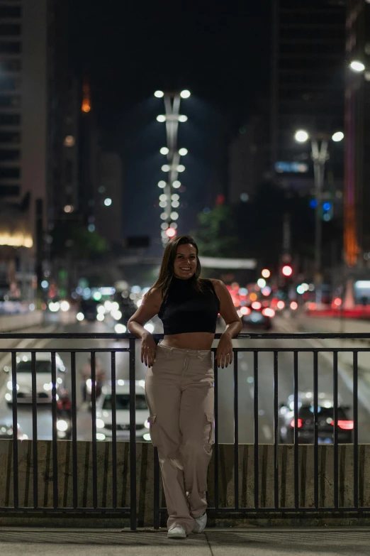 an image of woman posing by street at night