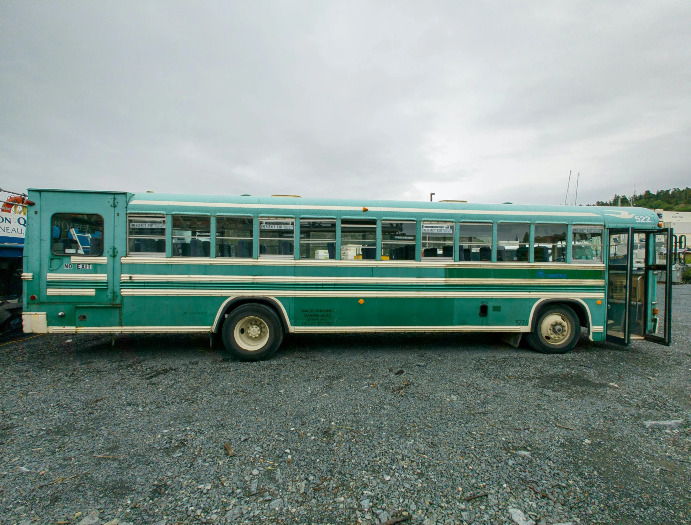 an old, green bus parked at the curb