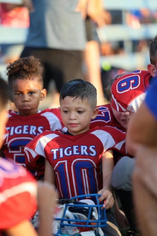 a group of children in jerseys standing next to each other