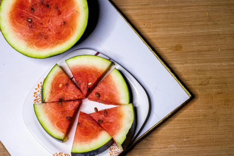 two watermelons cut in slices on a plate