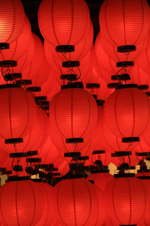 a collection of red lanterns lined up in rows