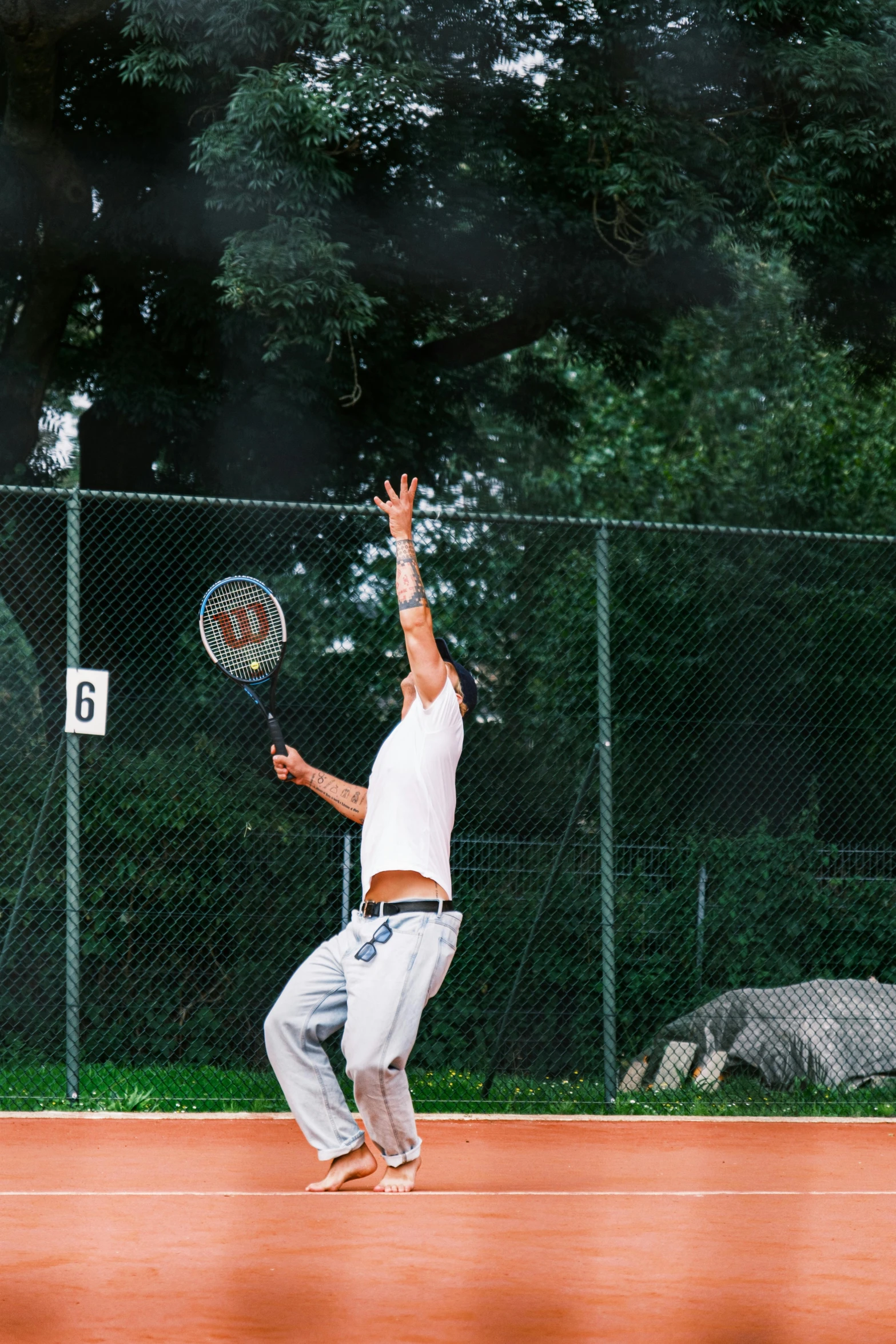 a man on a tennis court swinging his racket