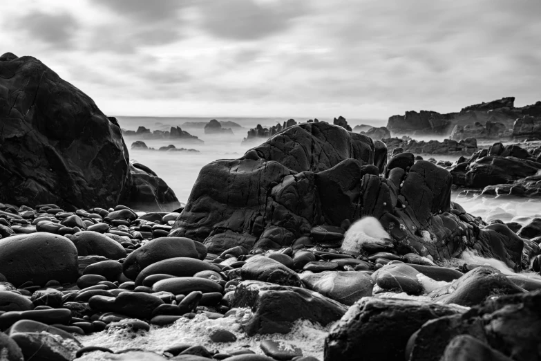 some very pretty rocks by the water with some water