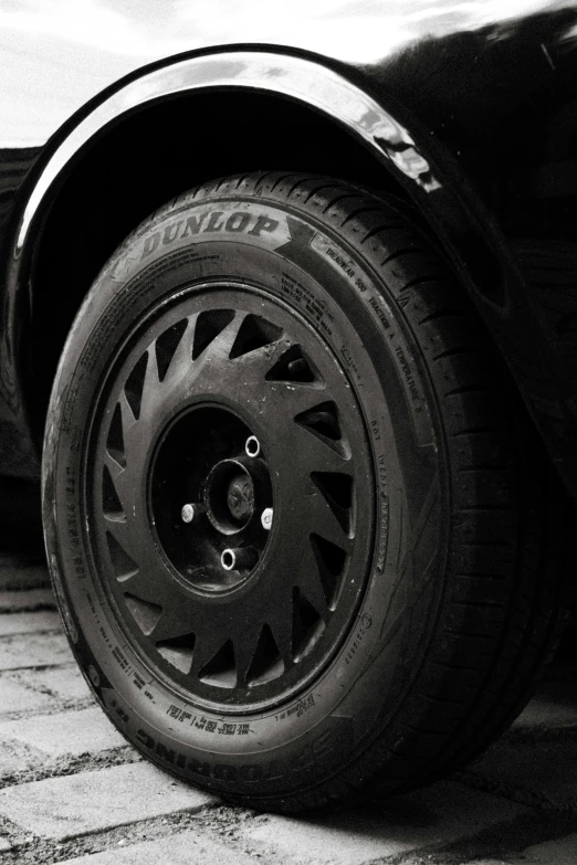 black and white pograph of a tire on a racing car