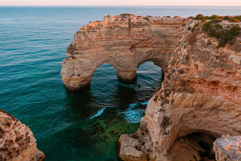 an arch shaped over looking the ocean from above