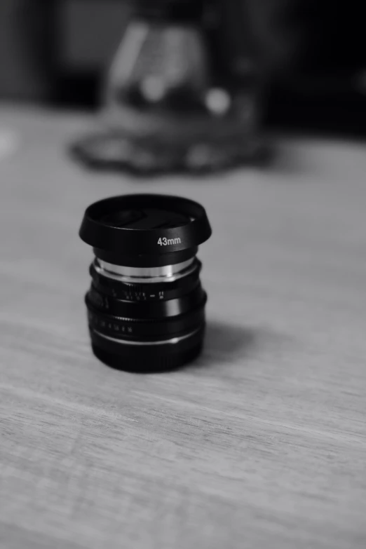 a black lens on a wood surface