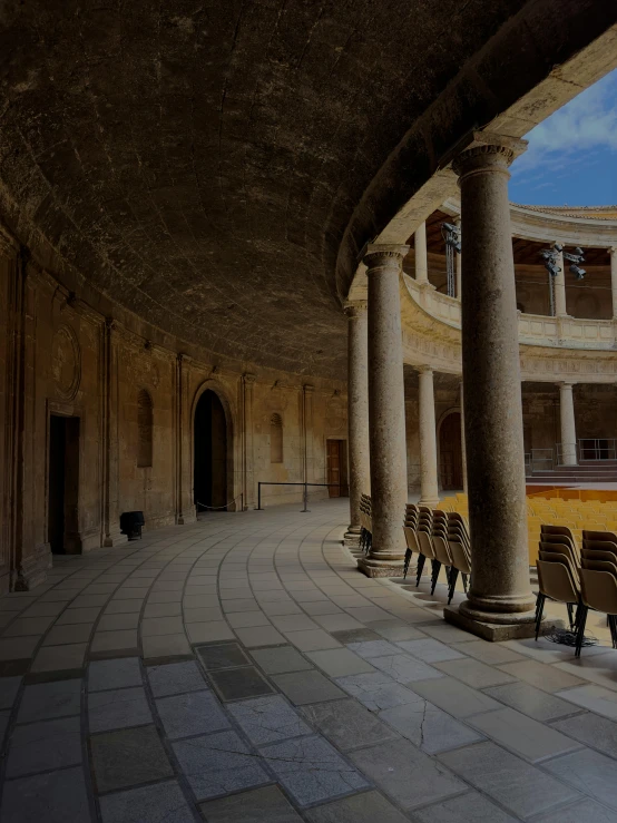 an empty room is surrounded by stone pillars and arches