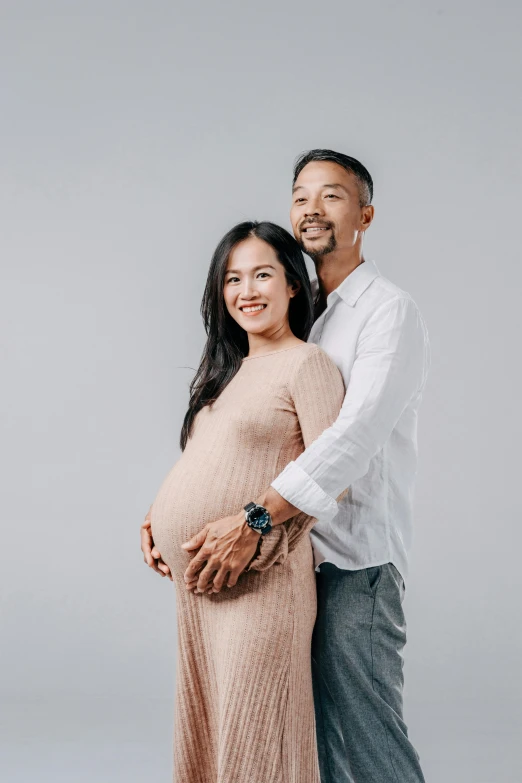 an image of a couple posing for their newborn po