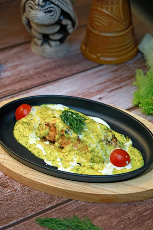 the fish dish is decorated with tomatoes and herbs