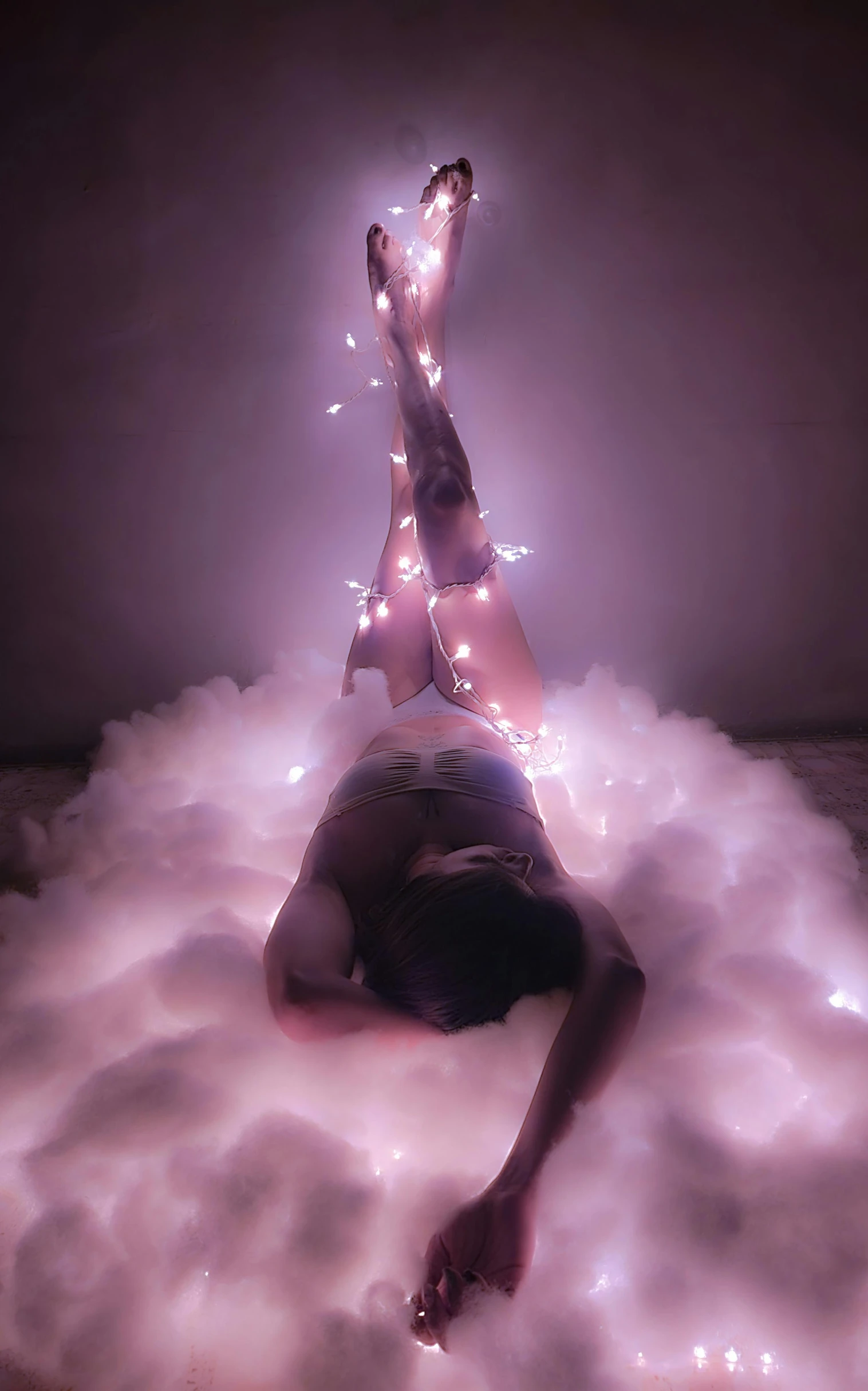 woman laying in a cloud full of white smoke