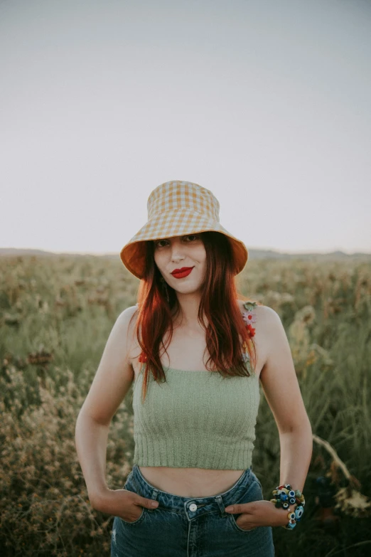 an image of woman wearing denim jeans and a hat