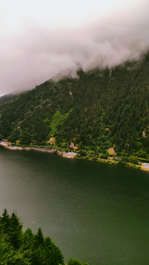 there are a few clouds rolling over the water