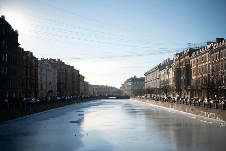 long snow and ice covered canal with people sitting in it