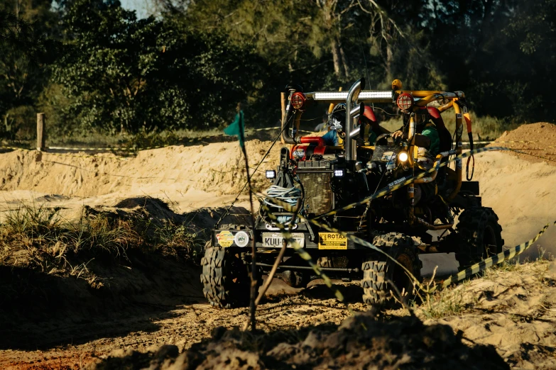 a couple of vehicles that are parked in the dirt