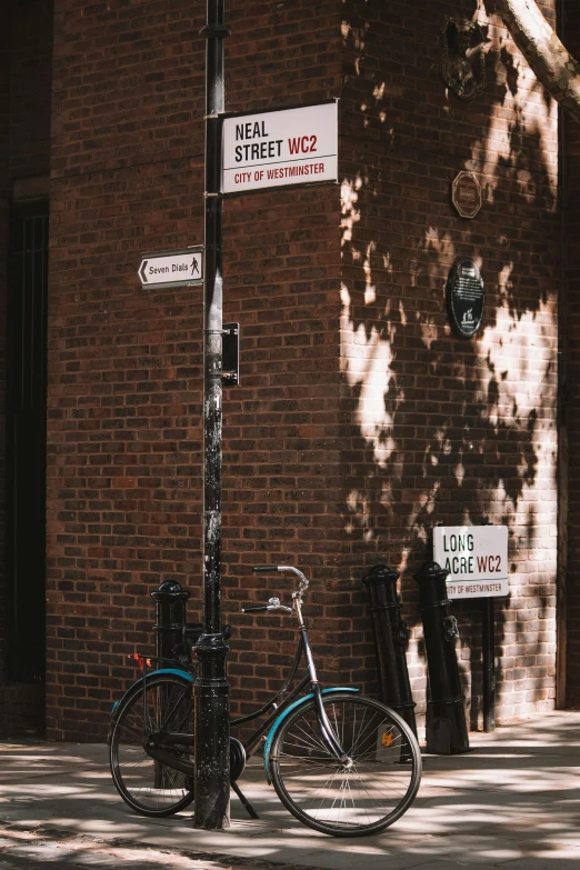 two bicycles are parked next to the signs