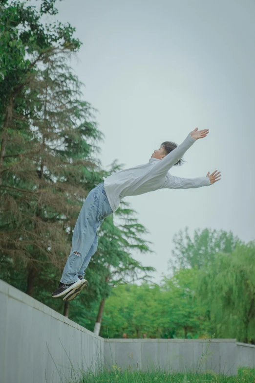 a skateboarder in a white shirt doing a trick