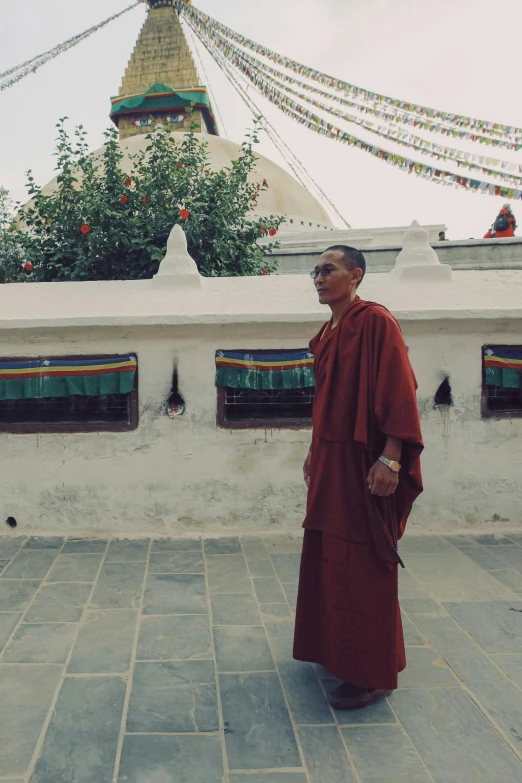 an asian man standing on a stone road