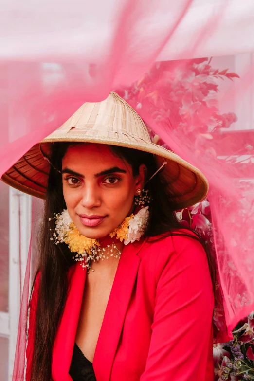 a woman wearing a hat and red clothing