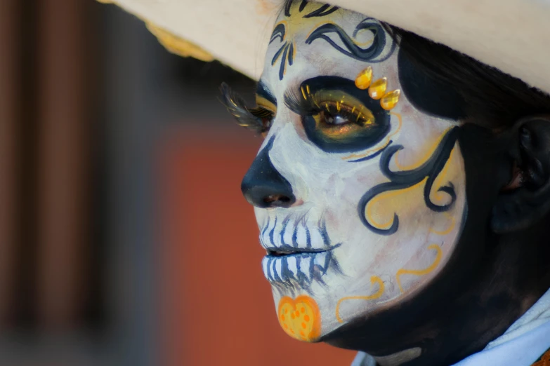 a woman with painted face and a hat