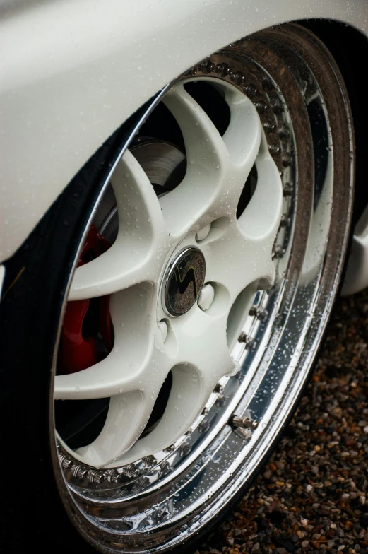 the tire and wheel rim of a white car