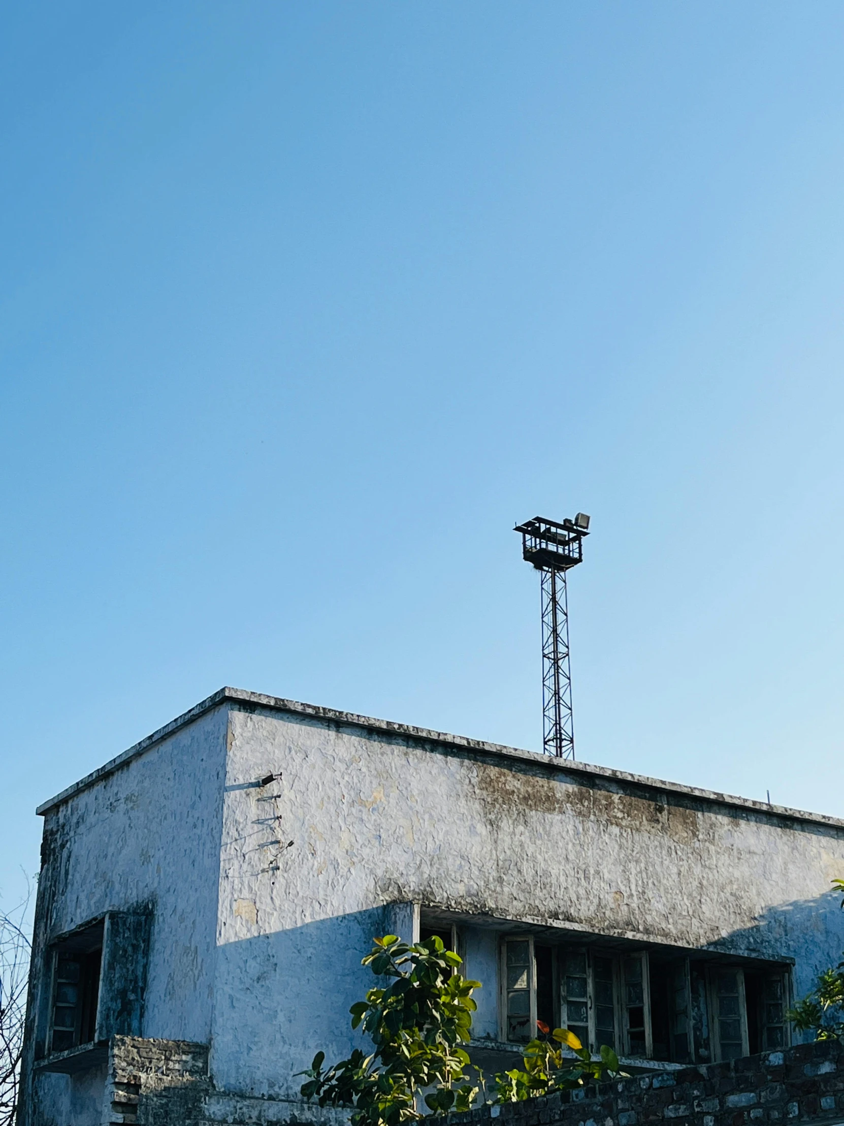 an old brick building with a wind tower on top