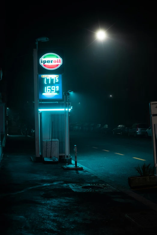 a gas station in the dark lit up at night