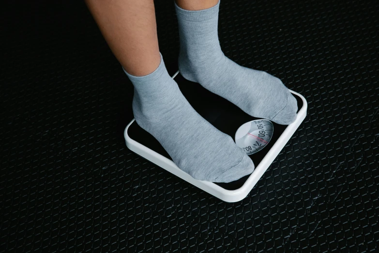 a person on a weighing machine wearing socks