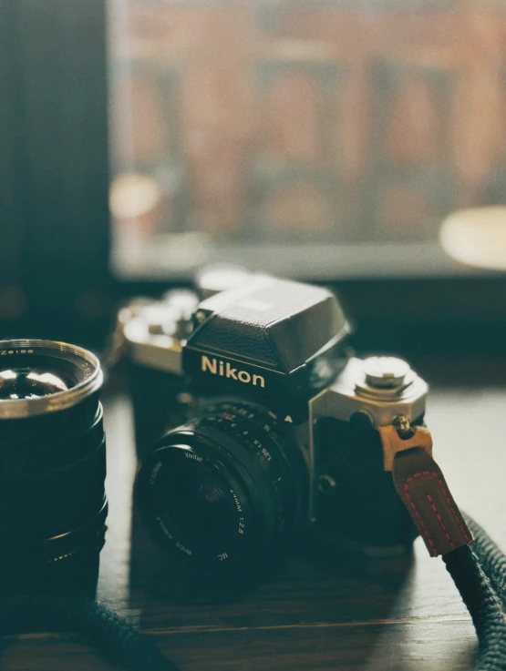 a camera with an attached flash drive is sitting on a table next to a can