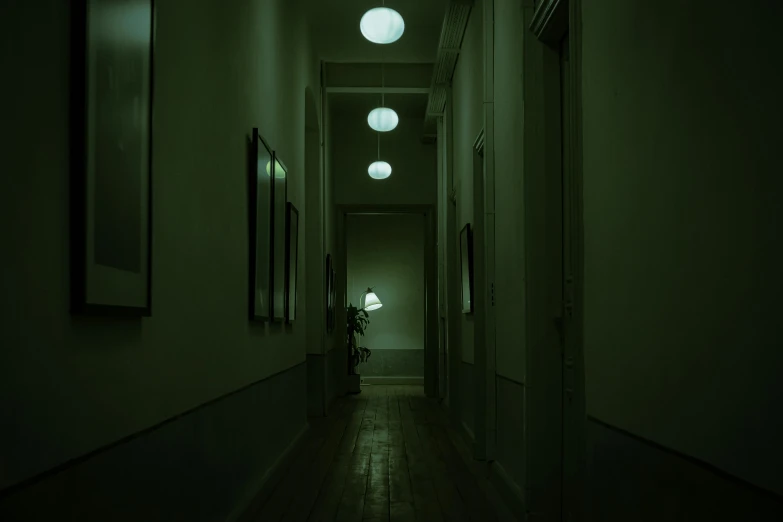 the hallway in the building is dark and empty