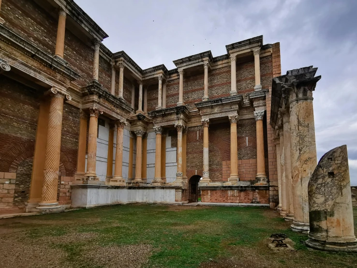 a large building with several columns and a person