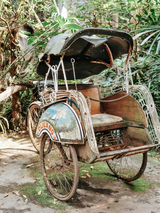 an old moped that is rusted and sitting on the ground