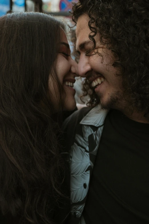two people kissing each other on the cheek
