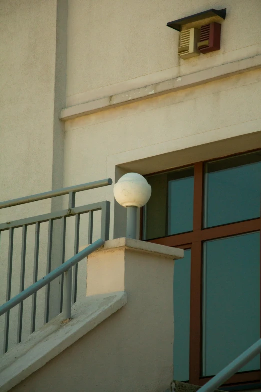 the light fixture is on above a balustrade