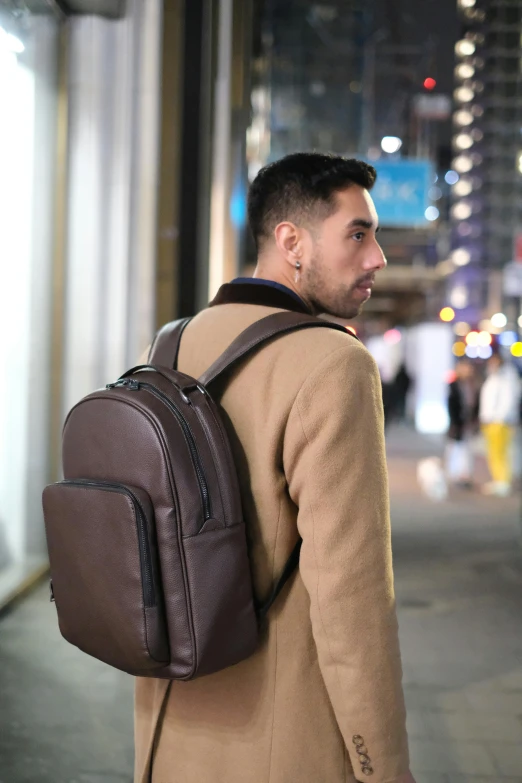 a young man is wearing a backpack and looking to the left