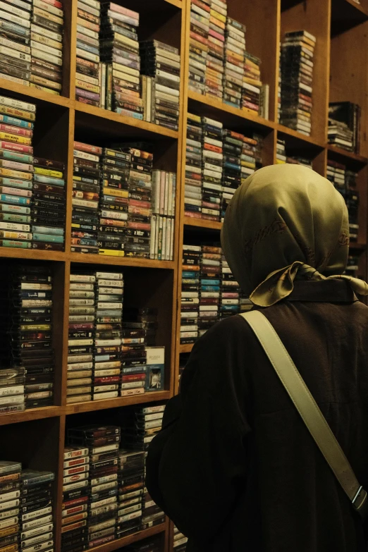 a person standing in front of a display of dvds