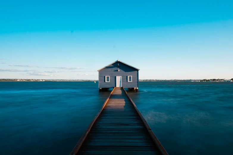 a pier leading to a house on the water