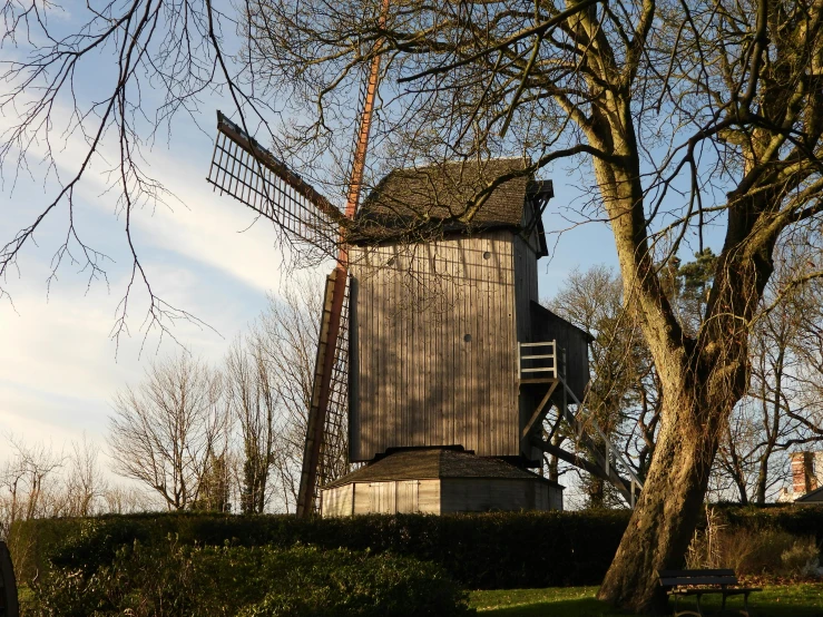 this is a windmill next to some trees