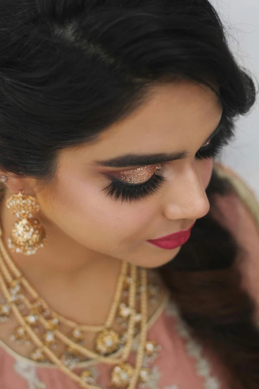 a woman with a makeup brush next to her face