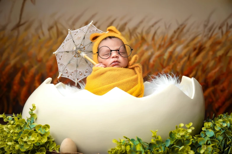 a small child is sitting in an egg with a cute hat on