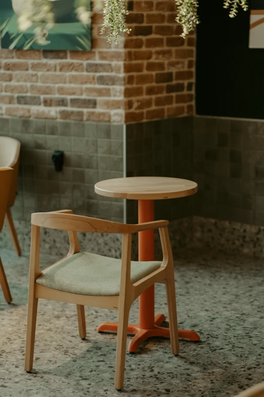 a wooden table sitting under a tree next to a chair