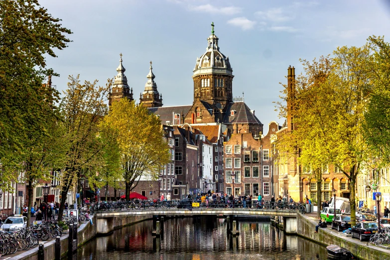 a small canal near some buildings and parked bikes