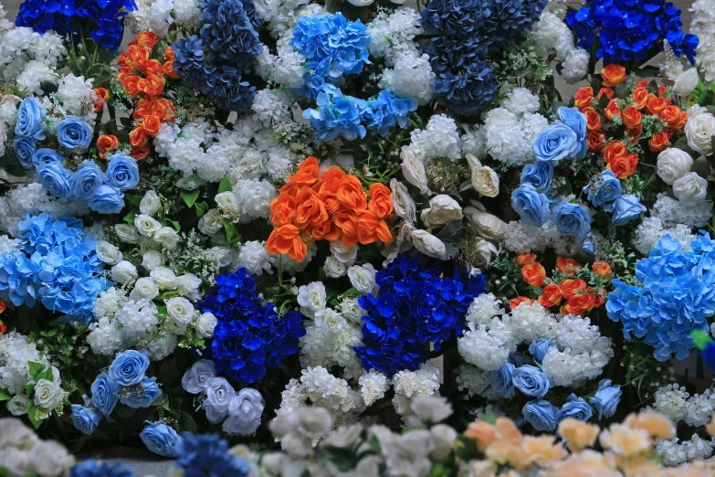 several colors of flowers are stacked together to create a colorful flower arrangement